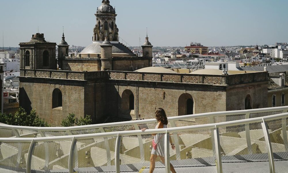 photo of woman walking on a bridge