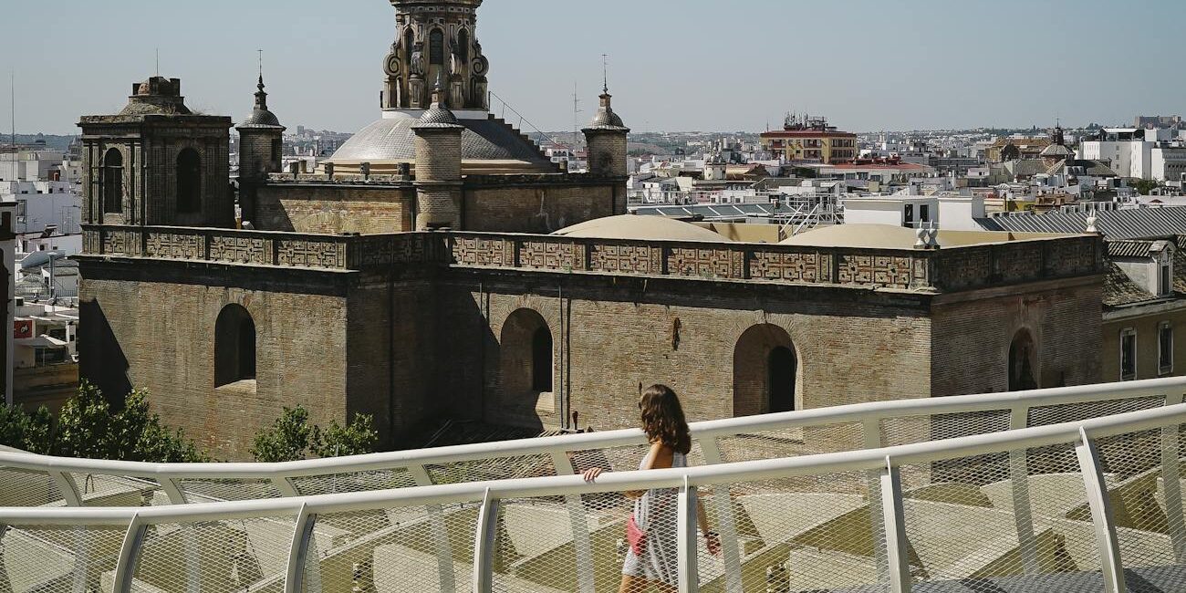 photo of woman walking on a bridge