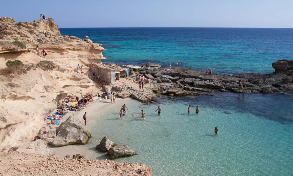 Tourist Robbed of Luxury Watch in Ibiza as Bystanders Step In to Foil Getaway group of people on beach shore