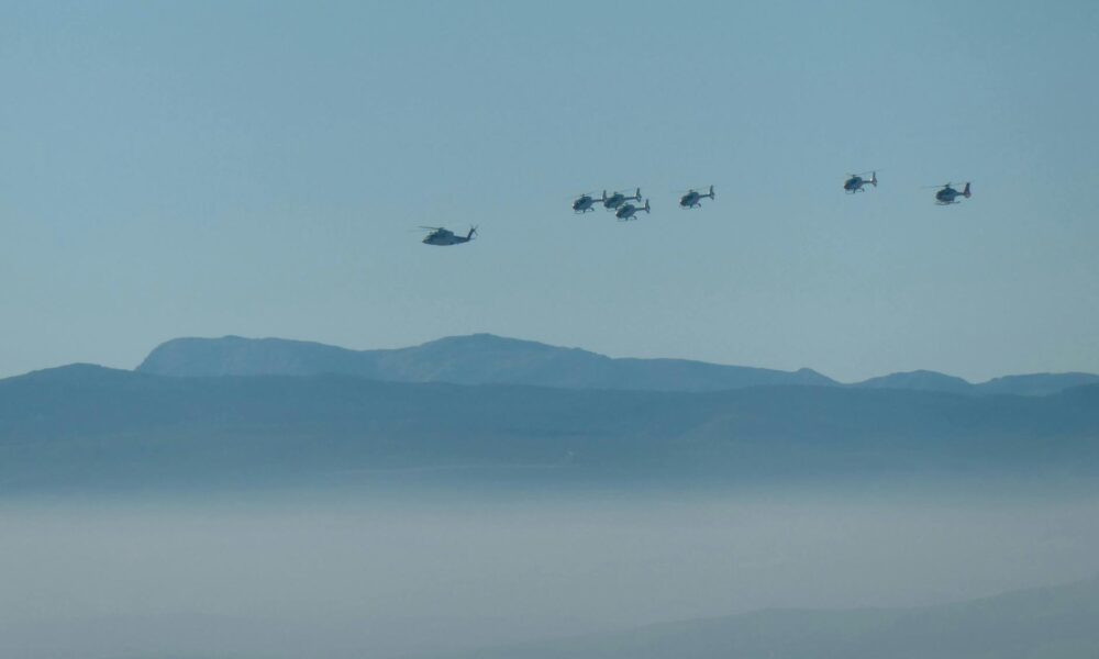 squadron of helicopters on sky