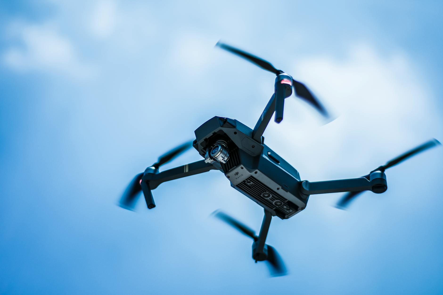 photo of gray quadcopter on the sky