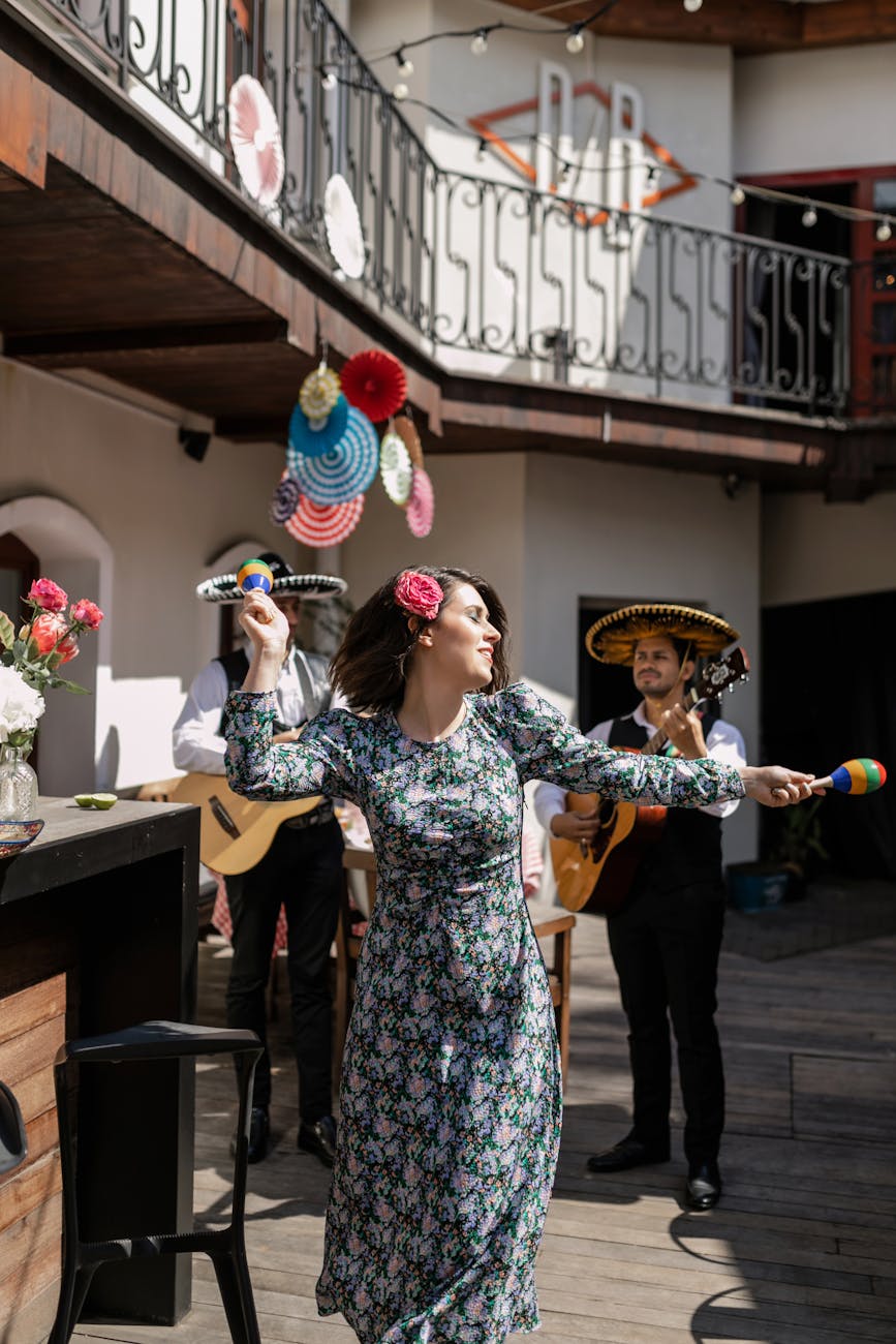 woman in floral dress holding maracas