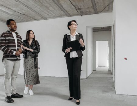couple and real estate agent in house