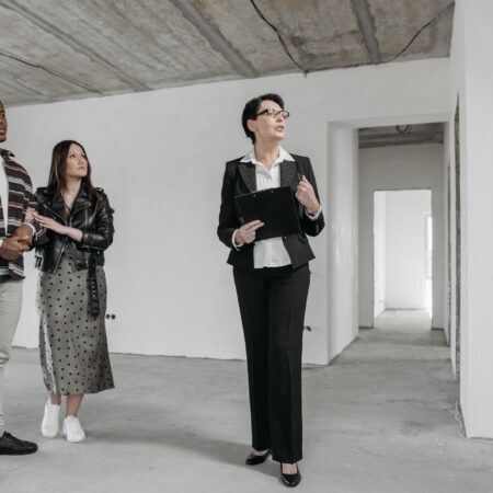 couple and real estate agent in house