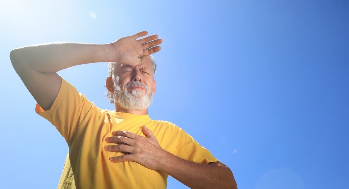 Senior man suffering from heat stroke outdoors